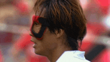 a close up of a person wearing a mask with the letter d on it