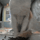 a cat standing next to a bowl of food with a sign in the background that says ' ein '