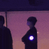 a person with a purple light on their arm