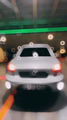 a white car is parked in a garage with bubbles coming out of it