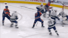a hockey game is being played in front of a sign that says ' sn ' on it