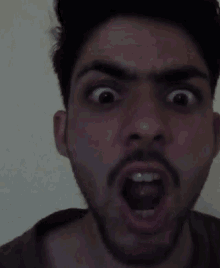 a man with a beard makes a funny face with his mouth open