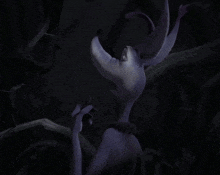 a cartoon character with a purple collar is smiling in a dark room