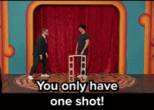 two men standing on a stage with the words you only have one shot