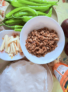 a bottle of apple juice sits on a table next to a bowl of ground meat