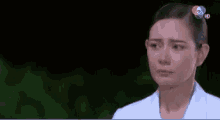 a woman in a white shirt is looking at the camera with a channel 7 logo visible in the corner
