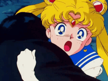 a girl with a heart on her head is hugging a black cat