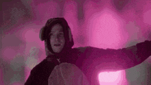 a man in a teddy bear costume is standing in front of a purple light .