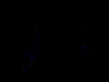 a person in a kimono is holding a sword in their hand in a dark room .
