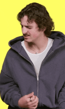 a man wearing a hoodie and a white shirt
