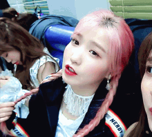 a girl with pink hair has a nerdy jacket on