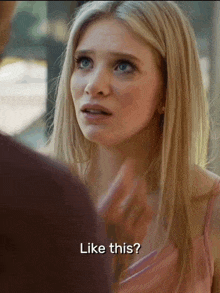 a woman in a pink dress is talking to a man and says like this