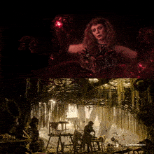 a woman with red hair is surrounded by red glowing objects in a dark room