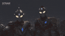 two ultraman are standing next to each other with flames coming out of their heads .