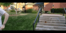 a person walking down a set of stairs in front of a building