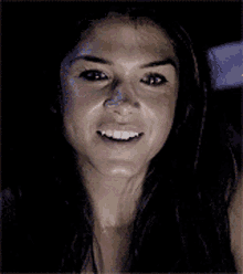 a close up of a woman 's face with her mouth open