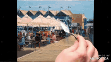 a hand is holding a palette knife in front of a painting that is made in animatica