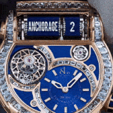 a gold watch with a blue face says anchorage at the top