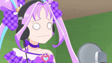 a girl with purple hair is wearing headphones and making a face