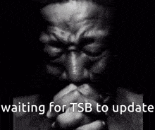 a black and white photo of a man praying with the words " waiting for tsb to update " below him