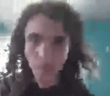 a close up of a person 's face with long hair .
