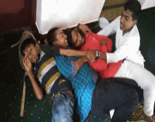 a group of young men are laying on the floor playing with each other
