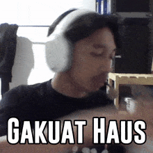 a man wearing headphones with the words " gakuat haus " on the bottom right