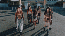 a group of girls are dancing in front of a store that sells famous lunch
