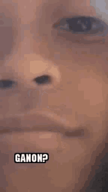 a close up of a person 's face with the word ganon written on it