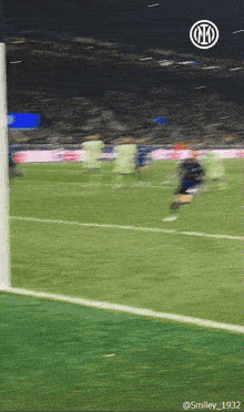 a blurry picture of a soccer field with the smiley 1932 logo in the corner
