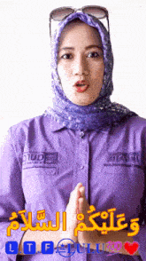 a woman wearing a purple shirt and a blue scarf says " ltf "