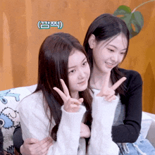 two girls are posing for a picture and one has a sticker that says ' i ' on it