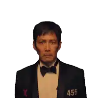 a man in a tuxedo and bow tie has the number 456 on his jacket