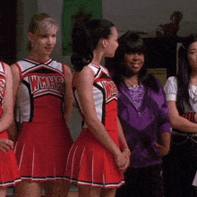 a group of cheerleaders wearing wmhs uniforms stand next to each other
