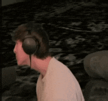 a man wearing a pair of headphones looks to his left