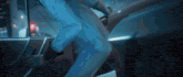 a person is getting out of a car with a blue light behind them
