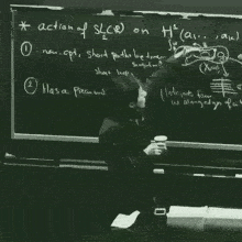a woman stands in front of a blackboard that says " action of slcr on h "