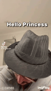 a man wearing a hat that says hello princess on it