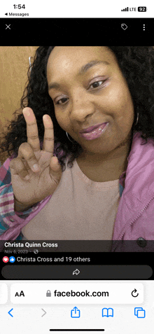 a phone screen shows a picture of a woman with the name christa quinn cross