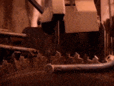 a machine is cutting a piece of wood with a circular saw .