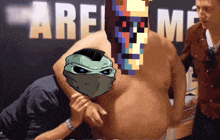 a man without a shirt has a pixelated face on his chest in front of a sign that says " are "