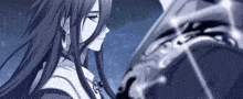 a woman with long black hair is standing next to a man with a sword .