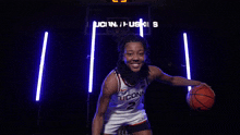 a female basketball player from uconn is posing for a photo