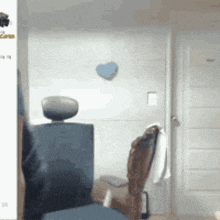 a room with a chair and a blue heart on the wall .