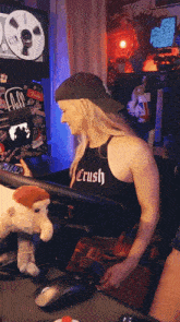 a woman wearing a black tank top that says crush on it
