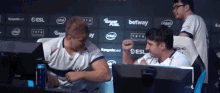 a group of people are sitting in front of a wall that has intel and betway on it