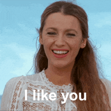 a woman in a white dress is smiling and says i like you