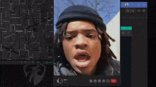 a man with dreadlocks is on a video call with a map behind him
