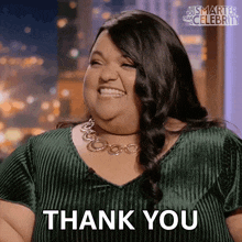 a woman in a green top is smiling and says thank you