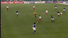 a soccer game is being played in a stadium and the goalie is wearing the number 12 jersey